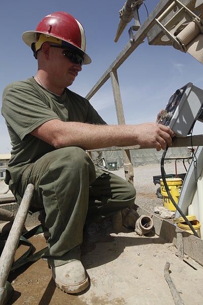U.S._Marine_Corps_Cpl._Jonathan_M._Klindt,_a_heavy_equipment_mechanic_with_Marine_Wing_Support_Squadron_271,_mounts_a_control_box_onto_a_skid-mounted_hydro_seeder_at_Camp_Leathernec_in_Helmand_province_130401-M-B