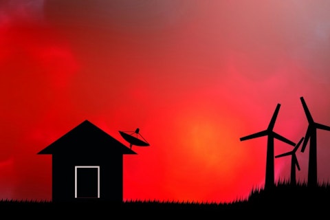 Dish Network DISH Shadow home with a satellite dish on the roof and the wind turbine sunset background