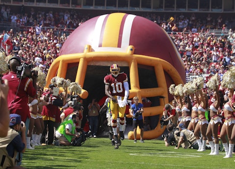 Washington Redskins quarterback Robert Griffin III runs onto the field during the first home game of the NFL season against the Cincinnati Bengals in Landover