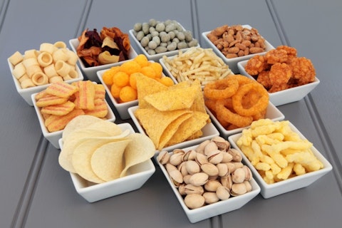 Savory snack party food selection in square porcelain bowls.