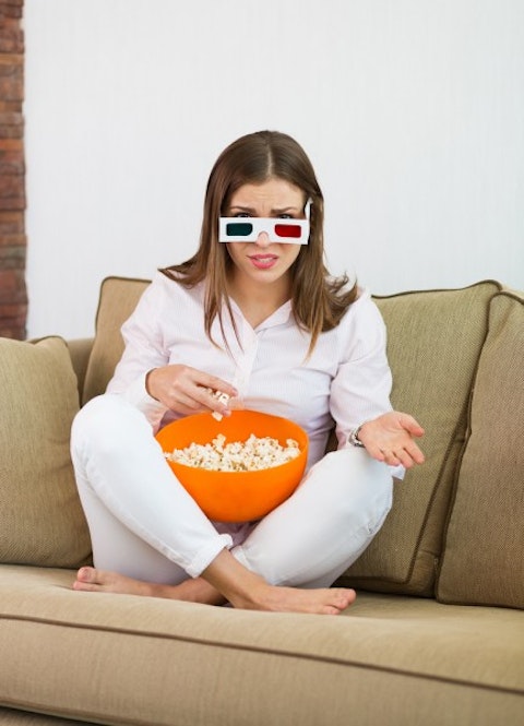 angry, annoyed, attractive, beautiful, bowl, brown, caucasian, cinema, corn, disappointed, dissatisfied, eating, enjoying, film, girl, glasses, hair, home, indoor,