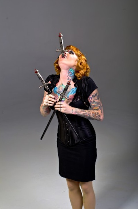 swords, swallower, sideshow, vaudeville, blond, female, dress, performer, girl, woman, blonde, actor, sexy, isolated, one woman only, alternative lifestyle, fashion, three, 11 Craziest Records Registered in The Guinness Book