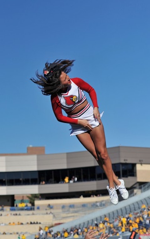 acrobat, acrobatic, air, blue, cheerleader, college, female, fly, football, girl, lady, louisville cardinals, ncaa, pregame, spirit, stunt, twist, woman, 10 Most Prestigious Cheerleading Squads