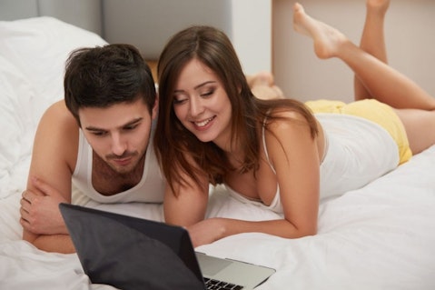 bed, bedroom, caucasian, computer, couple, female, hair, happy, home, internet, laptop, love, lying, male, man, mature, people, technology, together, using, woman, young