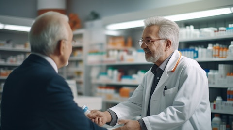 A pharmacist handing out a pharmaceutical drug to a patient in a drug store or chemist.
