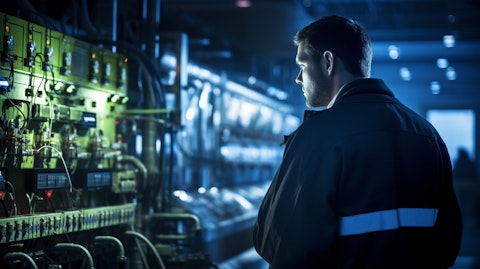 A technician in a power station monitoring the flow of energy generated by a gas turbine.