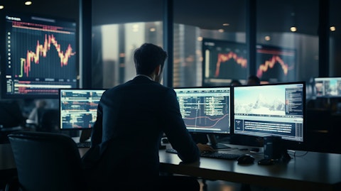 A group of finance professionals analyzing market trends on their computer screens.