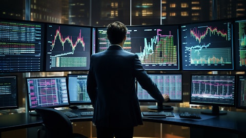A financial analyst monitoring the stock market, with multiple screens of varying sizes and colors.