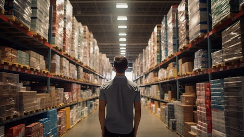A customer in a warehouse aisles, browsing the wide range of branded and private-label products.