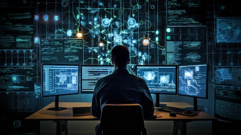 A software engineer at work, surrounded by a wall of computer monitors connected to a 'Data Cloud' platform.