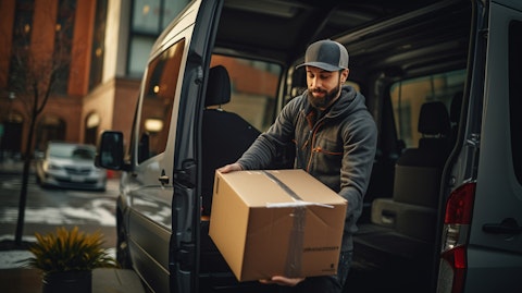 A driver unloading packages from a van for a time-critical delivery.