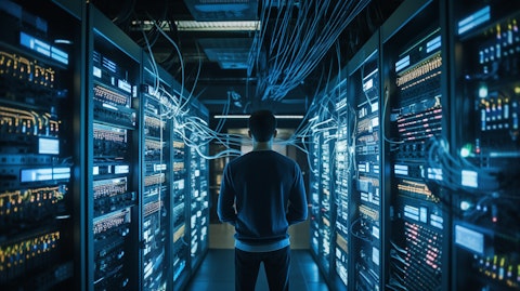 A technician in a server room managing a large-scale network of computers.