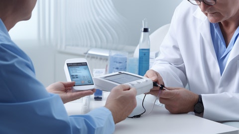 A doctor demonstrating how to use the medical device to a patient with diabetes.