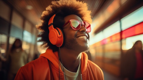 A person wearing headphones listening to an audio streaming service.
