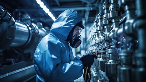 A technician wearing a protective suit in a water treatment plant.