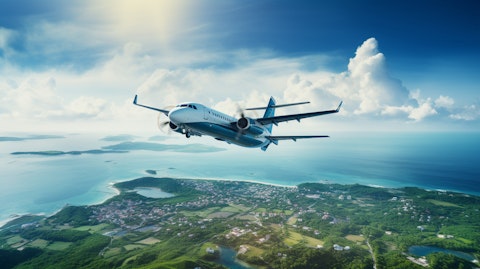 An aerial view of a commercial aircraft taking off from a coastal hub.