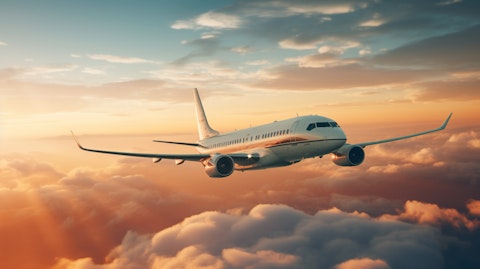 An aerial view of a commercial jetliner in flight, its airframe glinting in the sun.