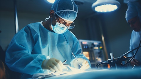 A surgeon performing a procedure in an operating room using a medical device supplied by the company.