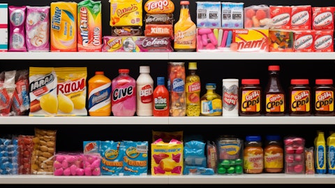 A colourful array of products like candies, chocolates and gums on a supermarket shelf.