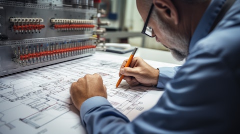 An engineer with a pen and paper designing a switchgear circuit diagram.