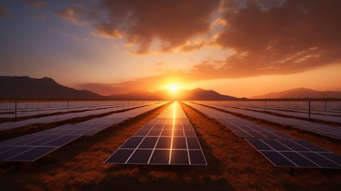 A solar panel farm with an orange sky illuminating the vast landscape.