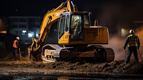 A construction crew operating a hydraulic shovel during a nighttime project.