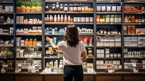 A photograph of a customer testing out different products in the skincare aisle at a store.