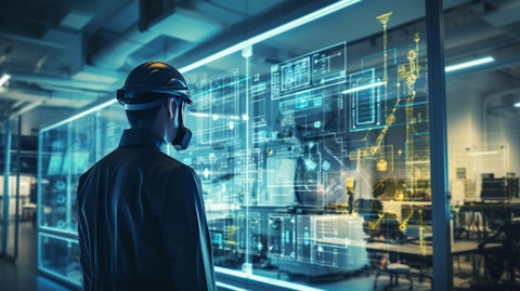 An engineer wearing protective gear overlooking a research and development laboratory.