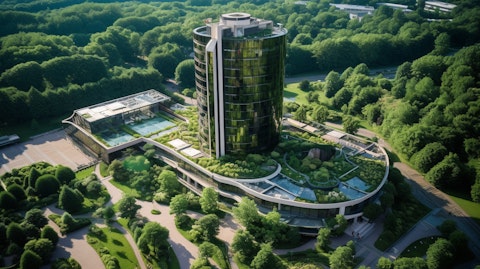 Aerial view of a luxury hotel tower surrounded by lush green landscaping.