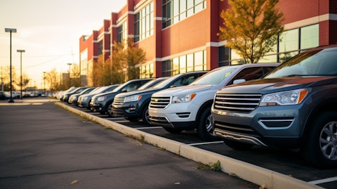 A fleet of cars parked at a car rental company's headquarters, symbolizing the company's commitment to servicing its customers.