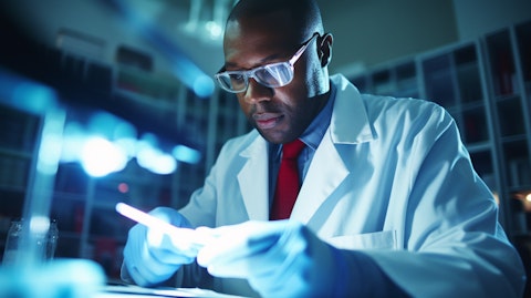 A research scientist in a lab coat examining a sample of blood for sickle cell diseases.