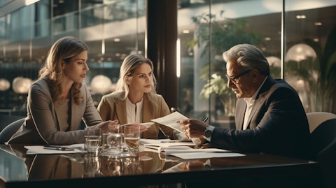 A shot of a financial advisor meeting with a wealthy couple discussing their portfolio.