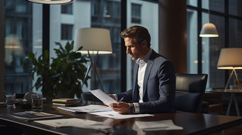 A financial advisor examining a client's portfolio at a modern office workspace.