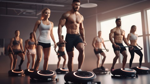 A group of people in a fitness class with connected fitness products in a studio or gym.