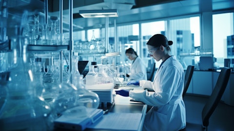 A research team in a laboratory discussing the results of a lab screening test for biomarkers.