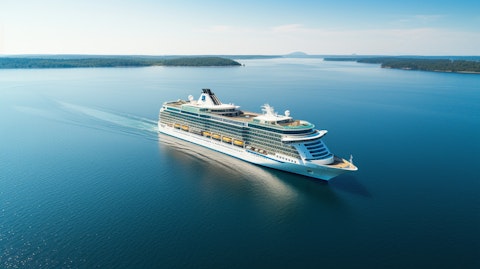An aerial view of a luxurious cruise ship, surrounded by the blue horizon.