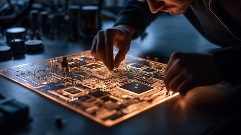 A technician overseeing an application-specific integrated circuit design, etched on a metallic plate.