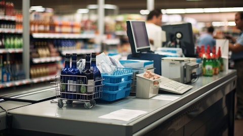 A customer buying an item at a checkout counter in a grocery store.