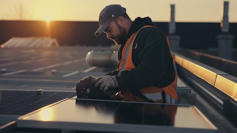 A technician installing a communication device in a large solar energy system.