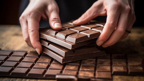 A close-up of hands deftly moulding a bar of chocolate.
