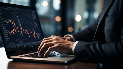A close-up of a portfolio manager's face with a laptop nearby, highlighting their expertise in investment management.