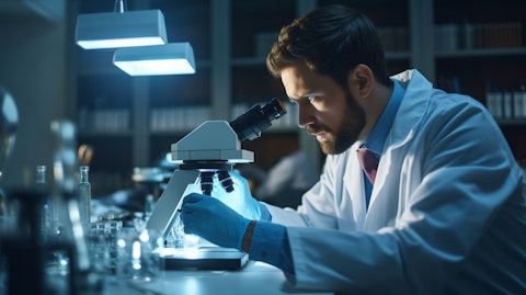 A healthcare worker in a lab coat, holding a microscope and reflecting on the diagnosis of a patient.