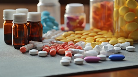 A close-up shot of various types of medicines on a table, illustrating the specialty and generic products offered by the pharmaceutical company.