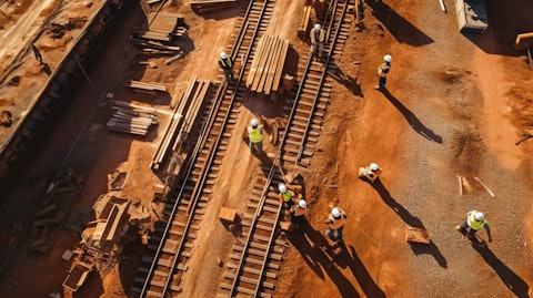 A high angle shot of a railway construction site, with workers in the frame.