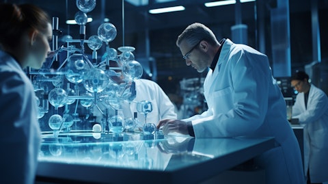 A team of scientists in lab coats studying a biopharmaceutical molecule in a lab.