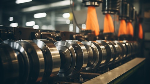 A closeup shot of a large industrial machine that manufactures steel cans.