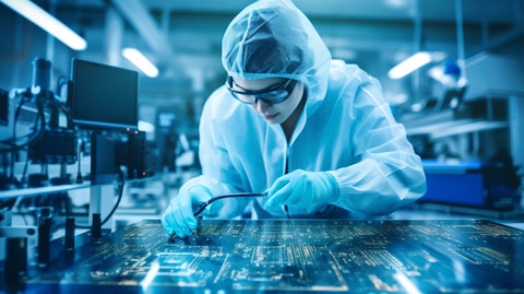 A technician examining a complex circuit board in a semiconductor development lab.