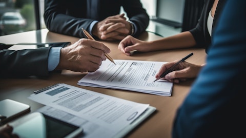 A financial advisor giving advice to a couple, illustrating the personal finance and insurance products the company offers.
