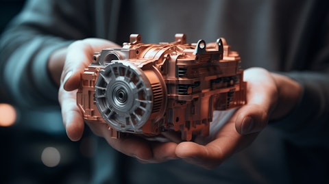 A closeup of a hand holding a car engine component, highlighting the precision of the company's engineering.