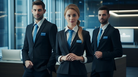 A corporate office with staff members wearing company branded uniforms.